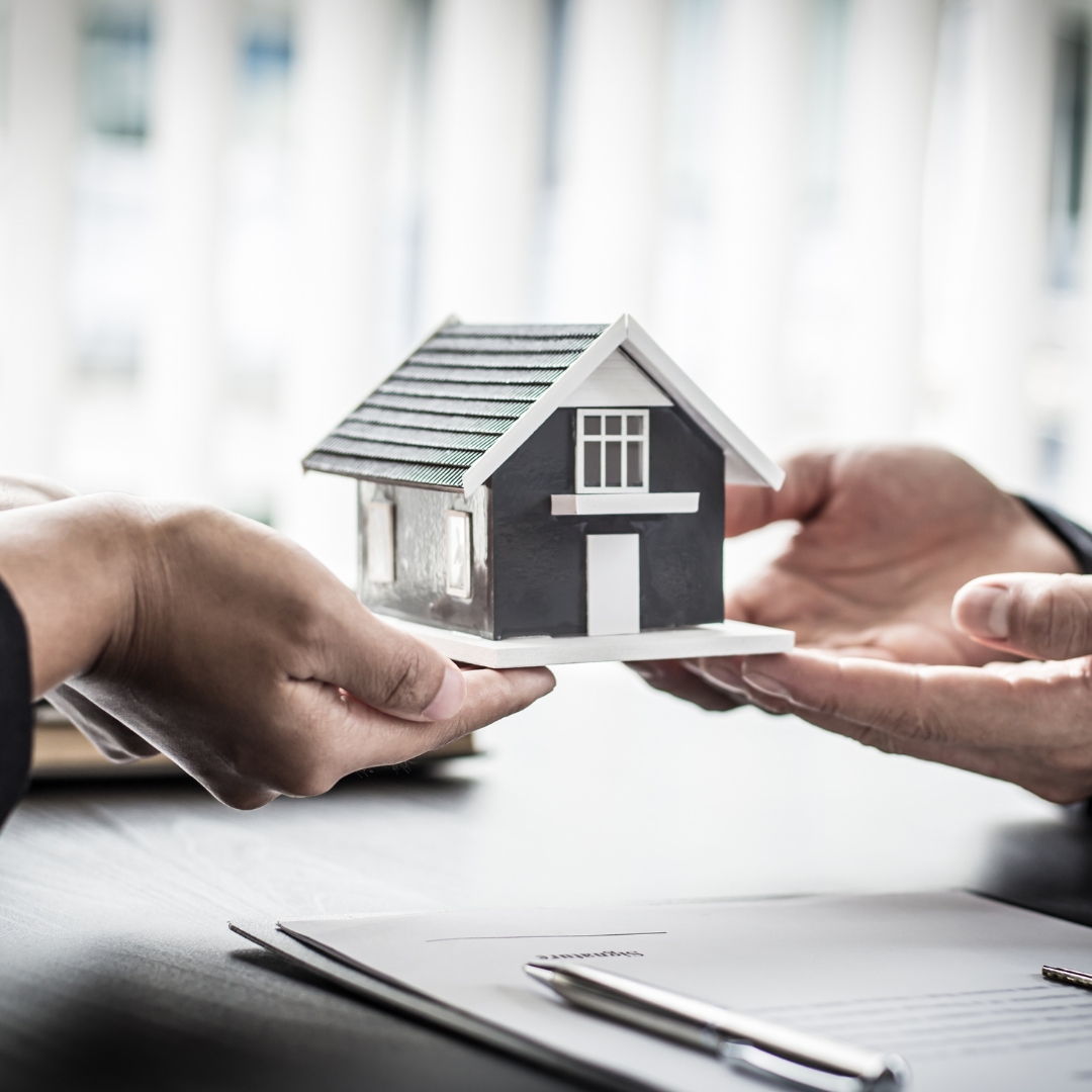 Agent and customer signing a home insurance policy